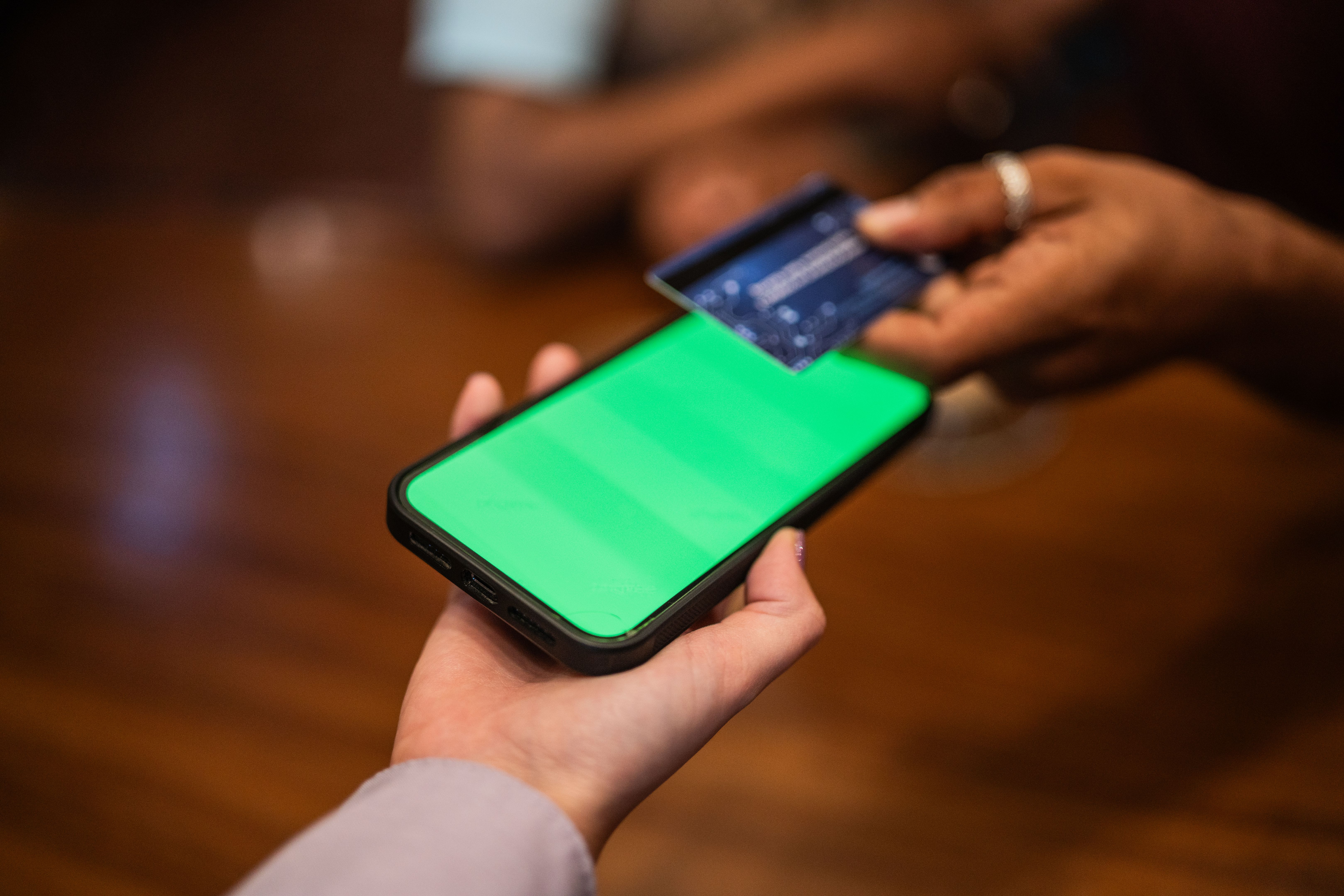 Card tap on green phone screen